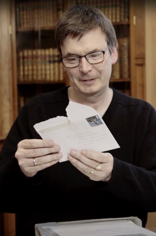 Ian Rankin looking at an archived letter