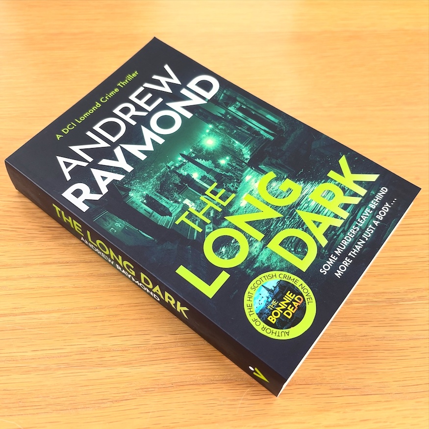 The Long Dark by Andrew Raymond three quarter shot of the book