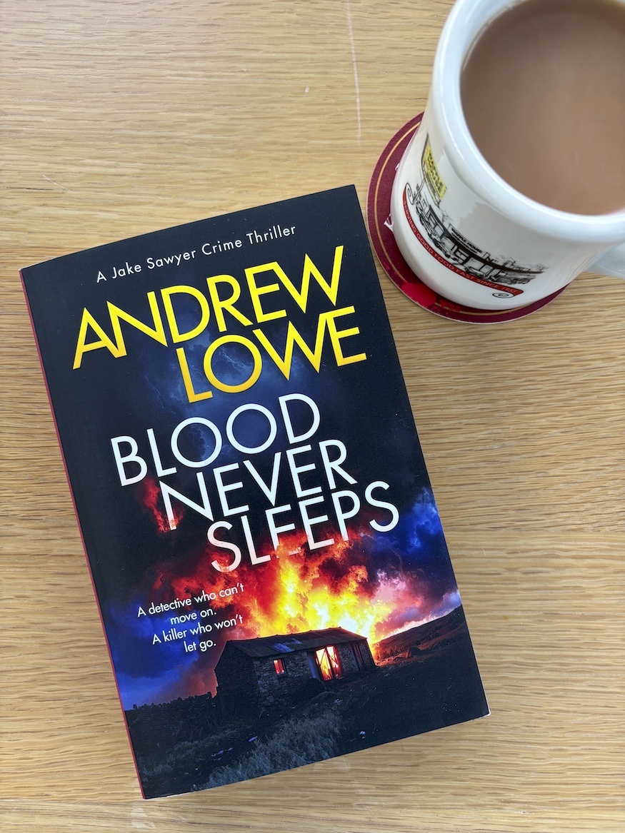 Blood Never Sleeps by Andrew Lowe overhead photo of book and mug of tea