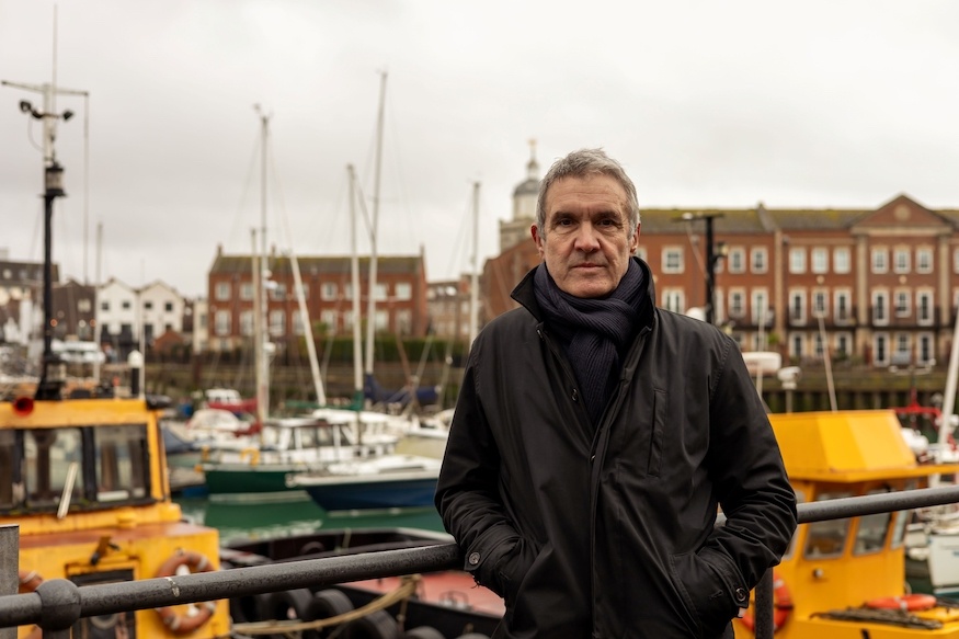 Crime fiction author Toni Viola with a marina as a backdrop
